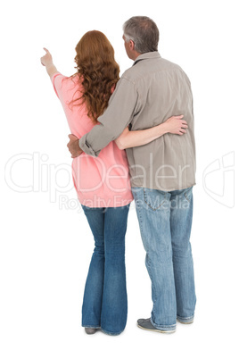 Casual couple standing arms around