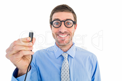 Geeky businessman holding a cable