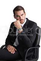 Serious businessman sitting on office chair posing