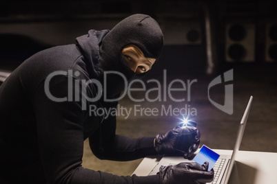 Robber shopping online while making light