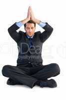 Calm businessman sitting in lotus pose with hands together