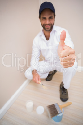 Painter showing thumbs up to camera