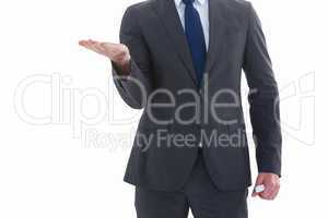 Businessman holding hand out in presentation