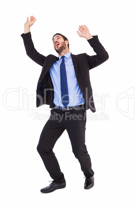 Shocked businessman standing and pushing up