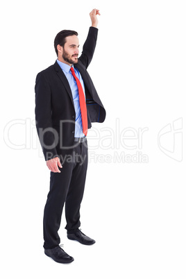 Smiling businessman standing with hand raised