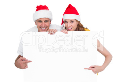 Festive couple showing a poster