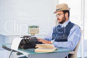 Businessman working on typewriter while smoking