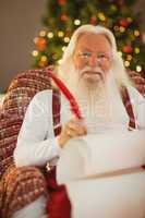 Happy santa writing list on the armchair