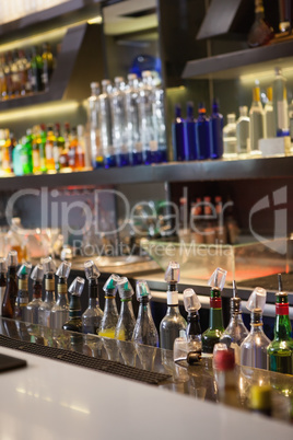 Close up on bar with bottle in a line