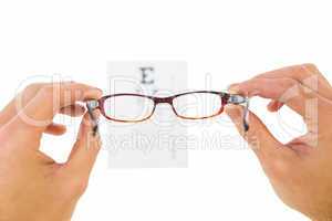 Glasses held up to read eye test