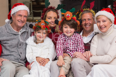 Multigeneration family wearing santa hats on the couch