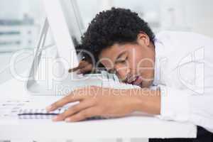 Handsome photo editor sleeping at desk