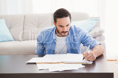 Focused man paying his bills