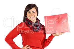 Smiling brunette showing red gift bag