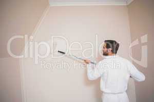 Painter painting the walls white