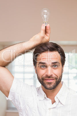 Man holding light bulb over his head
