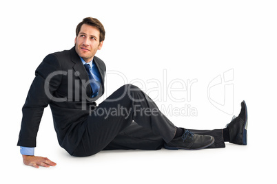 Businessman in suit sitting on floor