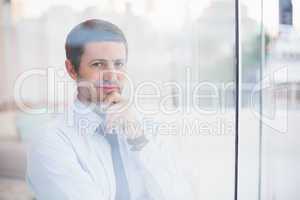 Smiling businessman looking out the window