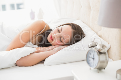 Pretty brunette lying in bed sleeping