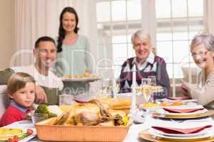 Woman holding christmas dinner with family at dinning table