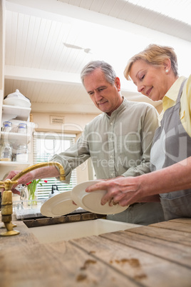 Senior couple washing the dishes