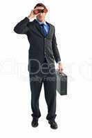 Businessman using binoculars while holding a briefcase