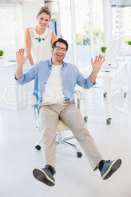 Man on swivel chair with hands up