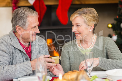 Senior man giving a christmas present to his wife