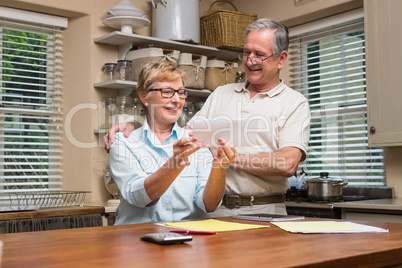 Senior couple working out their bills