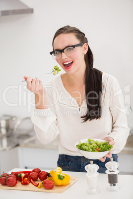 Pretty brunette preparing a healthy salad