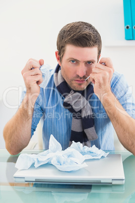 Stressed businessman looking at camera