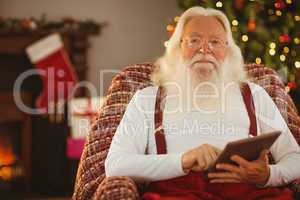 Smiling santa using digital tablet