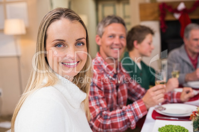 Woman smiling at camera during christmas dinner