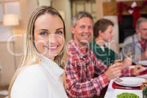 Woman smiling at camera during christmas dinner