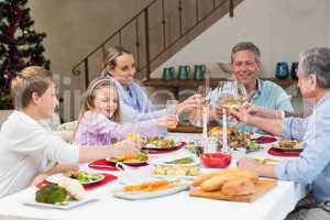 Family toasting with white wine in a christmas dinner