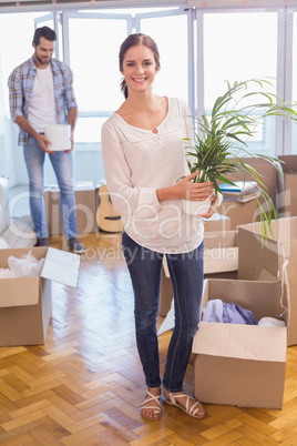 Cute couple unpacking cardboard boxes