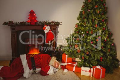 Santa claus sleeping on the rug