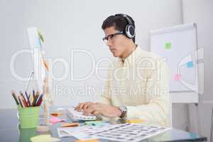 Serious designer listening music and working