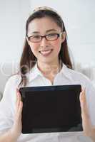 Businesswoman sitting and showing tablet