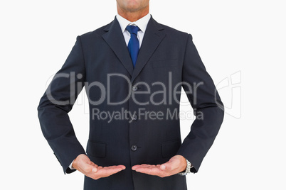 Mid section of a businessman in suit with hands out