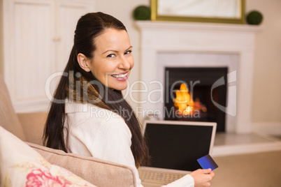 Woman doing online shopping with laptop and credit card