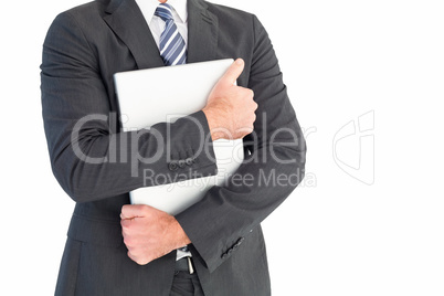 Businessman holding his laptop tightly