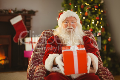 Santa claus offering a red gift