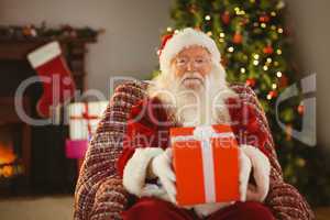 Santa claus offering a red gift