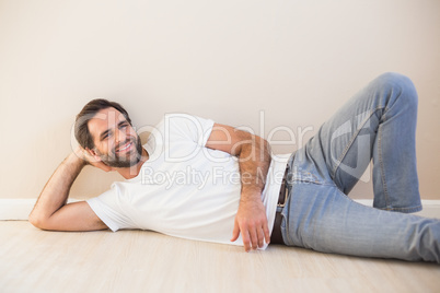 Happy man lying on the floor