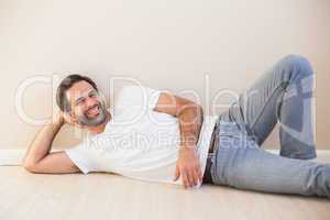 Happy man lying on the floor