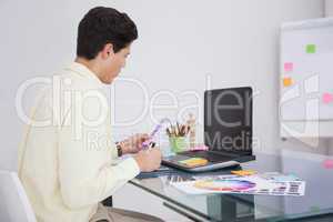 Designer using digitizer and colour sample