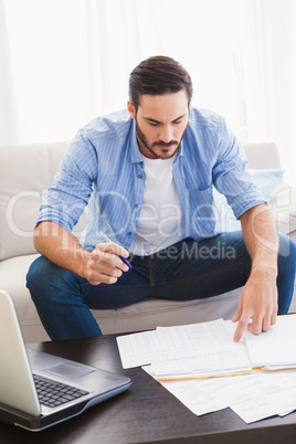 Focused man paying his bills