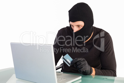 Burglar shopping online with laptop