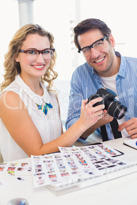 Portrait of photo editors with camera